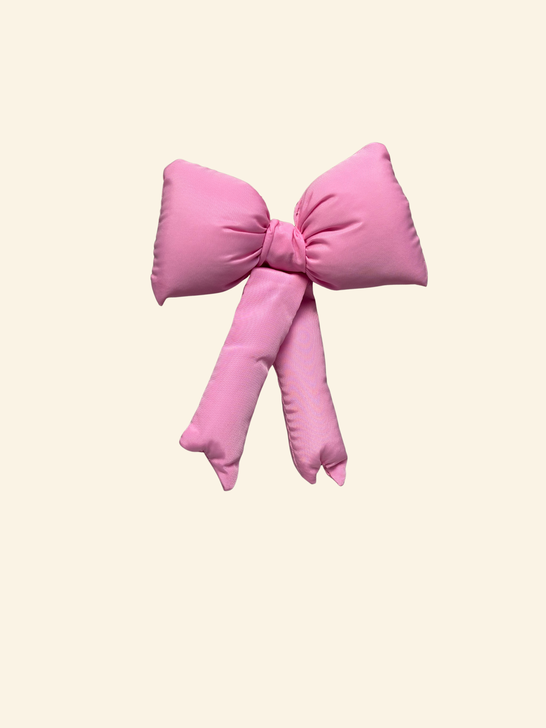 Pink puffy bow on a cream background