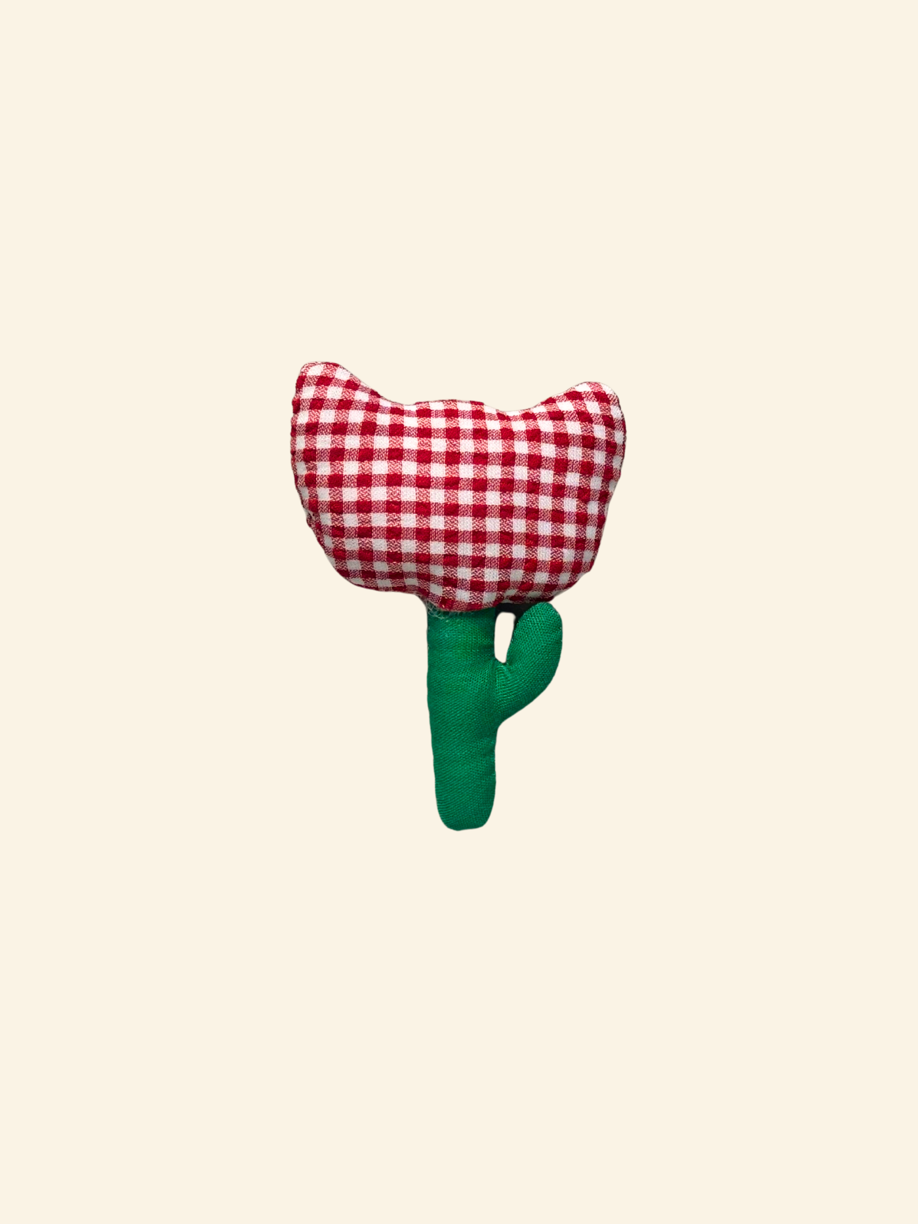 Puffy fabric tulip flower with red gingham top and green stem on a cream background